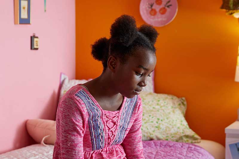 child sulking in her room